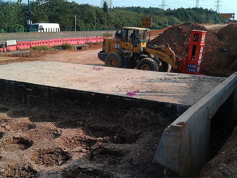 Rapid impact compaction equipment is compacting the back of the bridge